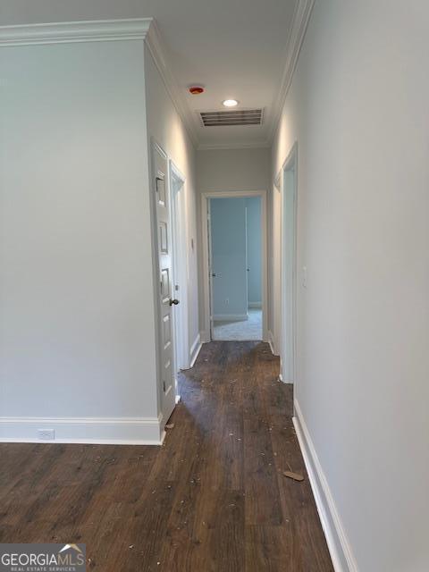 corridor with crown molding and dark hardwood / wood-style flooring