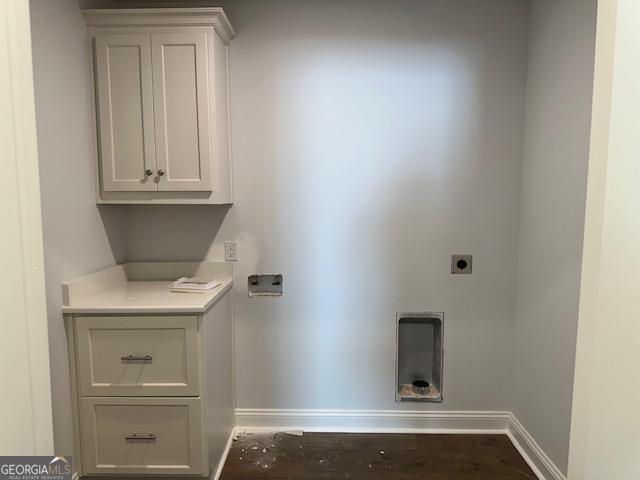 laundry area with cabinets and hookup for an electric dryer