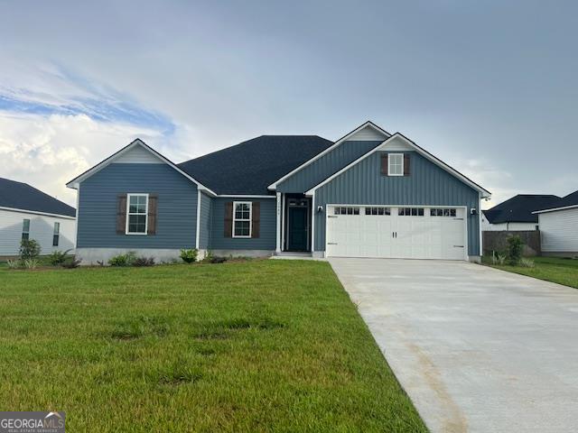 view of front of home featuring a garage and a front yard