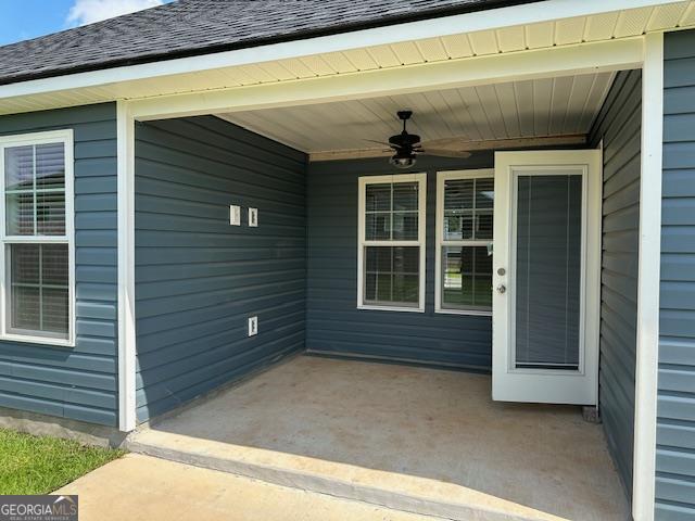 entrance to property with a patio and ceiling fan