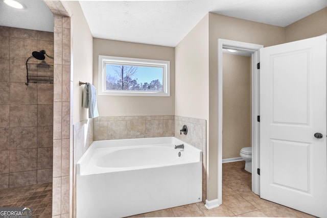 full bathroom with tile patterned flooring, a tile shower, toilet, and a bath