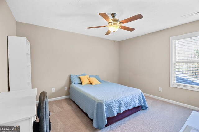 bedroom with carpet floors, a textured ceiling, and ceiling fan