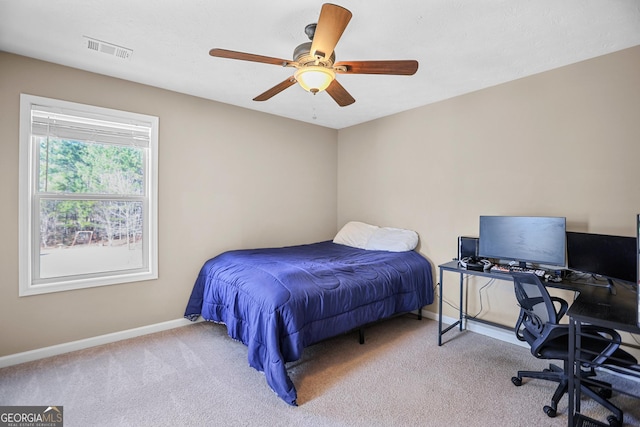 bedroom with ceiling fan and light colored carpet