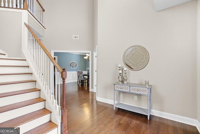 foyer featuring dark hardwood / wood-style flooring and a high ceiling