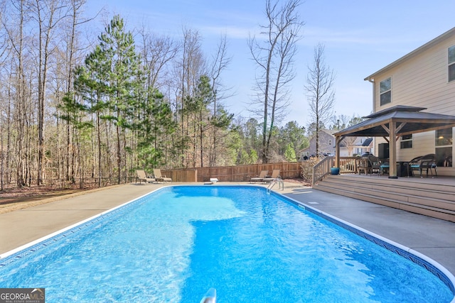 view of pool featuring a wooden deck, fence, and a fenced in pool