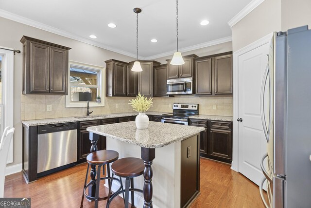 living room featuring crown molding, hardwood / wood-style floors, and ceiling fan