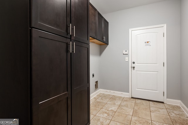 washroom with cabinet space, light tile patterned floors, baseboards, and hookup for an electric dryer