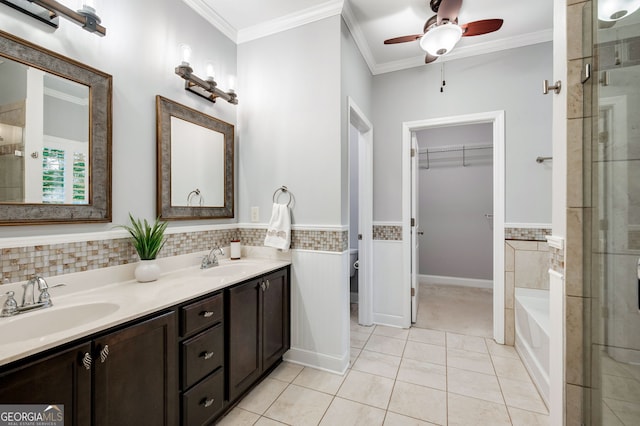 bathroom featuring crown molding, a garden tub, a sink, and tile patterned floors