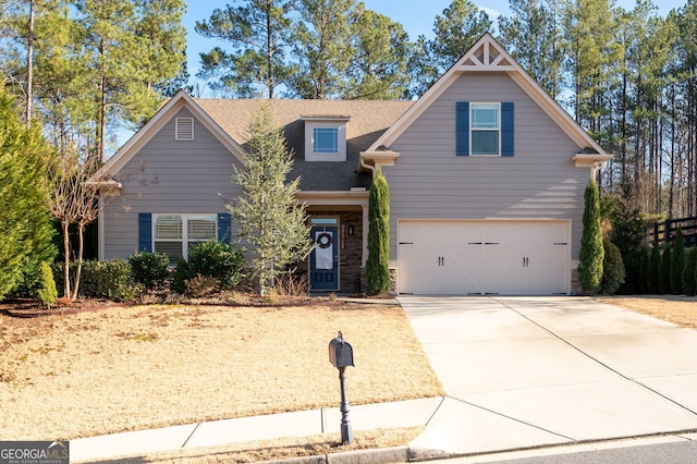 view of front facade with driveway, roof with shingles, and an attached garage