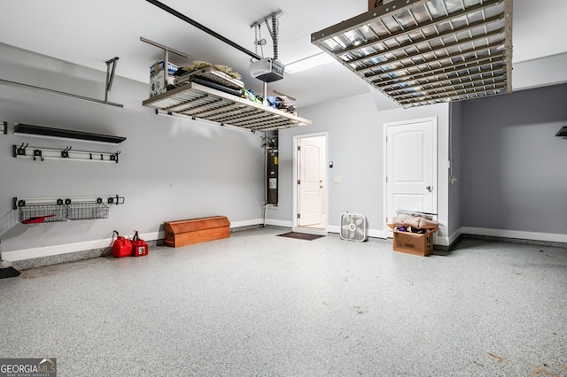 garage with a garage door opener, water heater, and baseboards