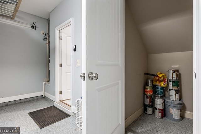 interior space with vaulted ceiling and baseboards