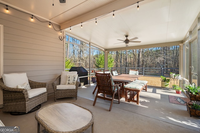 sunroom with ceiling fan and track lighting