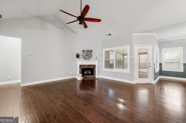 unfurnished living room with a fireplace, wood finished floors, visible vents, baseboards, and a ceiling fan