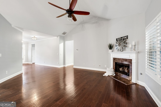 unfurnished living room featuring a premium fireplace, wood finished floors, visible vents, and baseboards