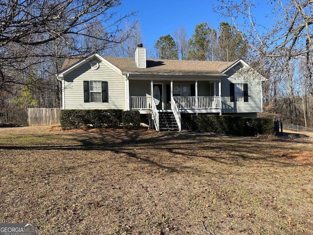 ranch-style home with covered porch and a front yard