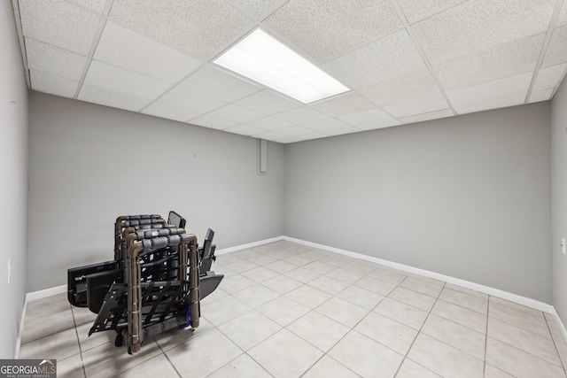 basement with a paneled ceiling