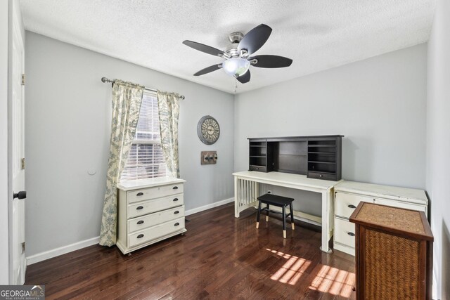 office space featuring ceiling fan, dark hardwood / wood-style floors, and a textured ceiling