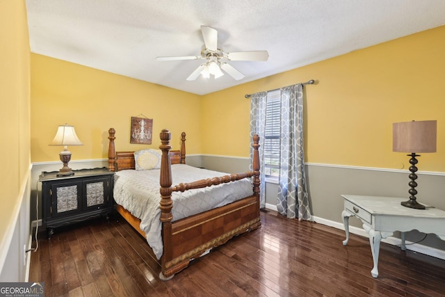 bedroom with dark hardwood / wood-style floors and ceiling fan