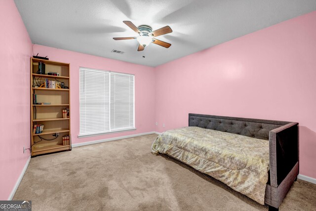 bedroom with ceiling fan and light colored carpet