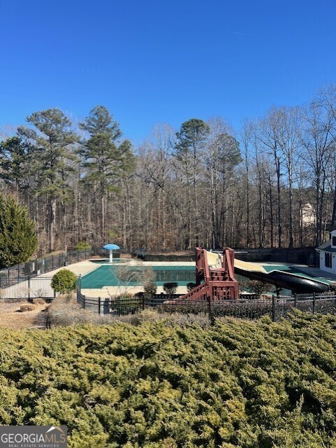 exterior space with a playground and a swimming pool