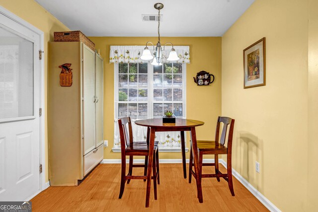 kitchen featuring sink, backsplash, stainless steel appliances, light stone counters, and light wood-type flooring