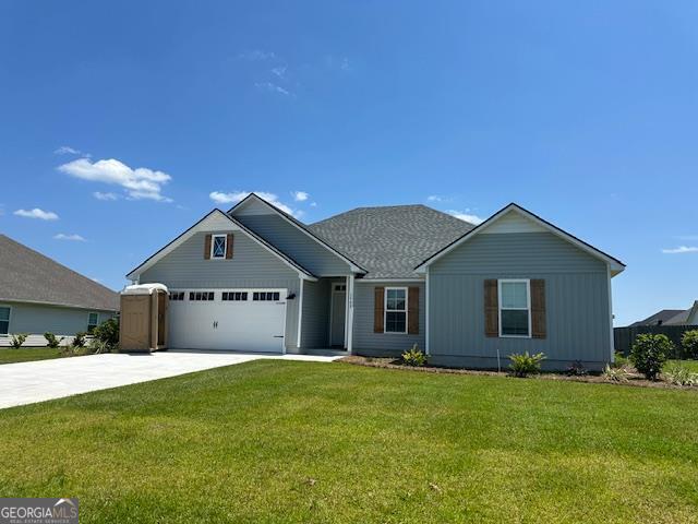 view of front facade with a garage and a front lawn