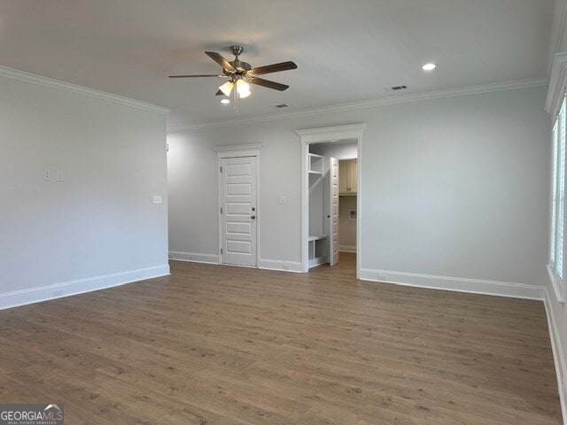 spare room with ceiling fan, ornamental molding, and dark hardwood / wood-style floors