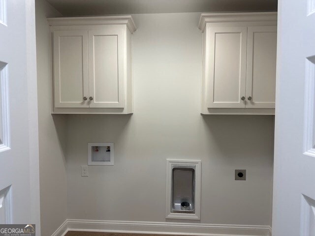 clothes washing area featuring cabinets, washer hookup, and electric dryer hookup