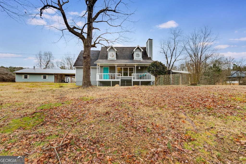 view of front of house featuring a carport and covered porch