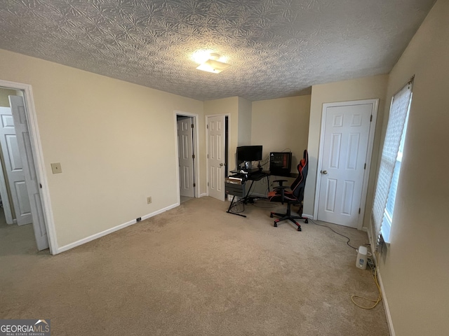 carpeted office with a textured ceiling