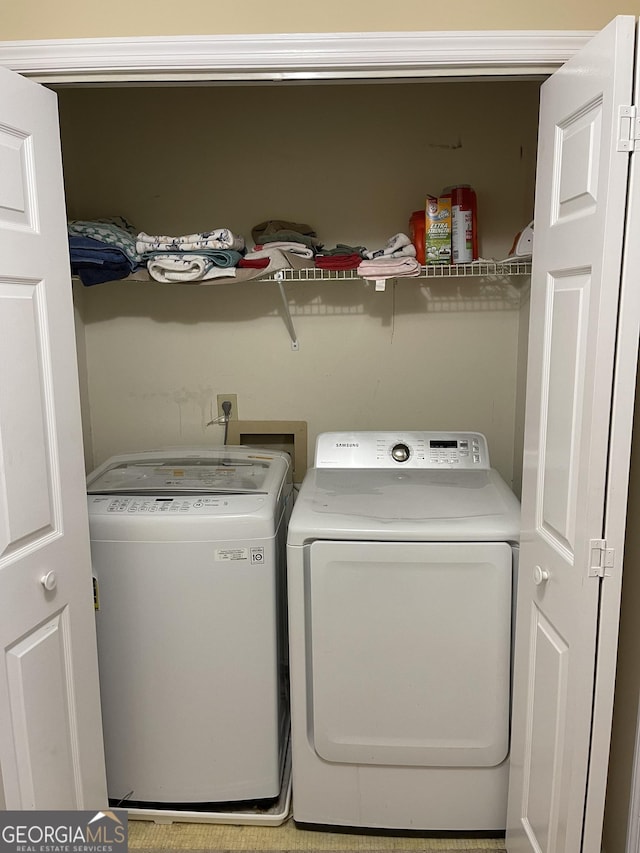 clothes washing area featuring washing machine and clothes dryer