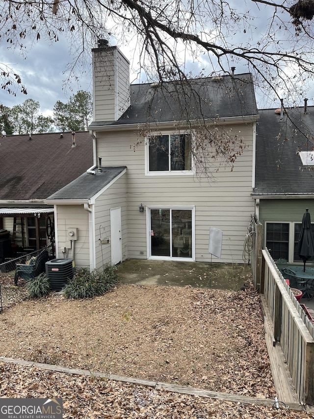 rear view of property with a patio area and central air condition unit