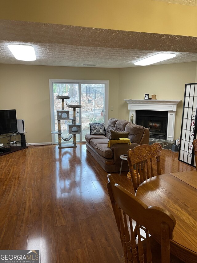 living room featuring hardwood / wood-style floors and a textured ceiling