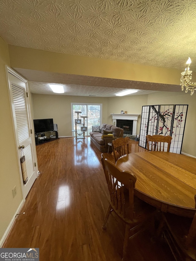 dining area featuring hardwood / wood-style flooring and an inviting chandelier