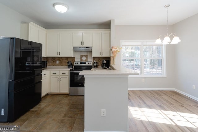 kitchen with black refrigerator, white cabinetry, and electric range