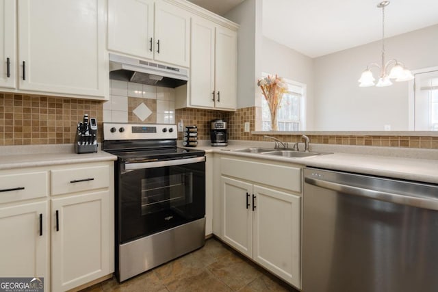 kitchen with pendant lighting, white cabinetry, sink, backsplash, and stainless steel appliances