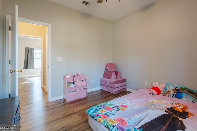 bedroom with ceiling fan and dark hardwood / wood-style flooring