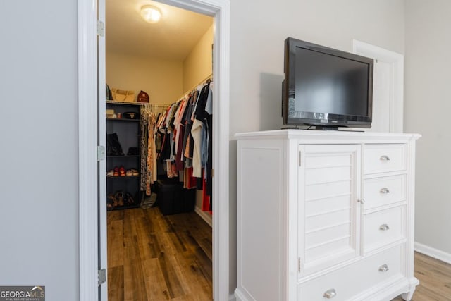 walk in closet featuring hardwood / wood-style floors