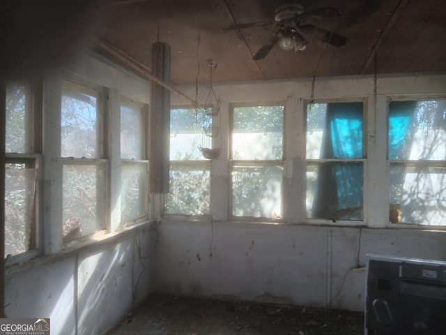 unfurnished sunroom featuring plenty of natural light and ceiling fan