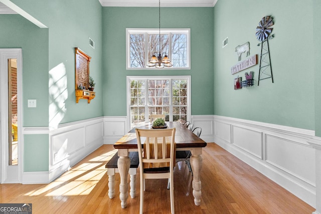 dining room with a notable chandelier and light hardwood / wood-style floors