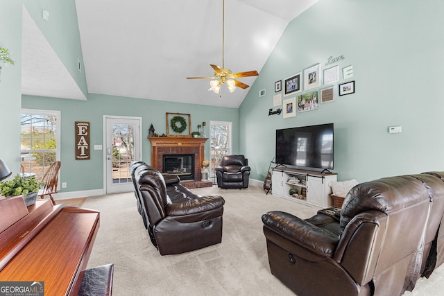 living room featuring ceiling fan, light colored carpet, and high vaulted ceiling