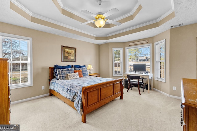 bedroom featuring a raised ceiling, crown molding, and light colored carpet