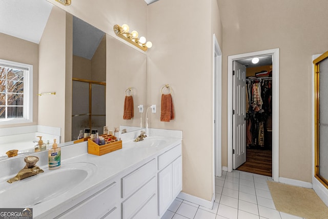 bathroom featuring tile patterned floors, shower with separate bathtub, and vanity