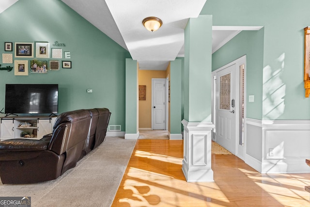 living room with wood-type flooring and decorative columns