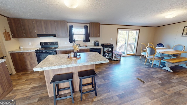 231 Canady Bridge Rd, Twin City, GA 30471 - kitchen with black appliances, extractor fan, a textured ceiling, dark wood-style flooring, and light countertops