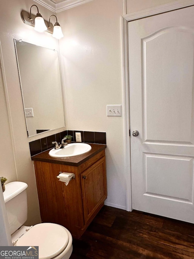 bathroom with vanity, hardwood / wood-style floors, and toilet