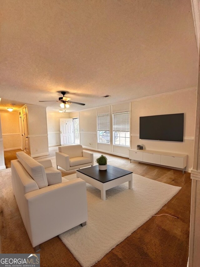 spare room featuring a textured ceiling, ceiling fan, and carpet flooring