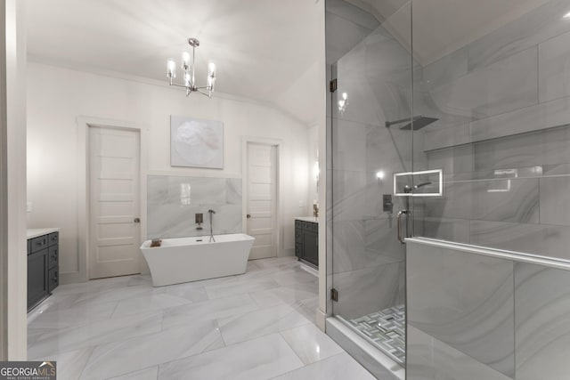 bathroom with an inviting chandelier, vanity, separate shower and tub, and tile walls