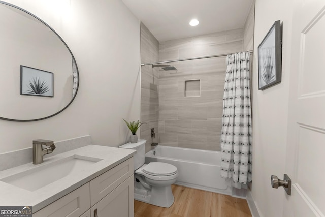 full bathroom featuring shower / bath combo, hardwood / wood-style floors, vanity, and toilet