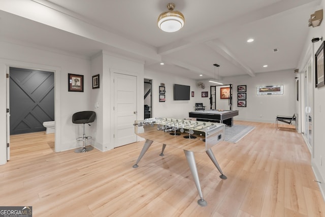 playroom with beam ceiling and light wood-type flooring